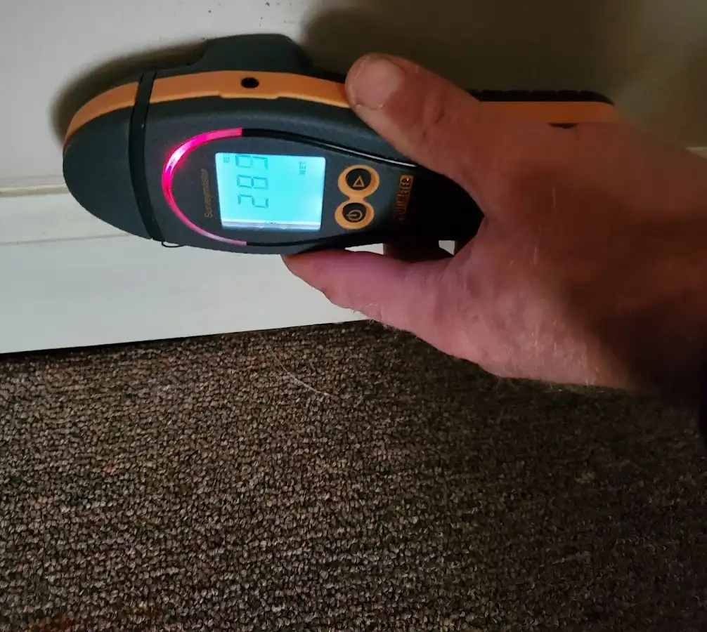 Moisture detection at baseboard during Storm Damage Restoration in Montebello